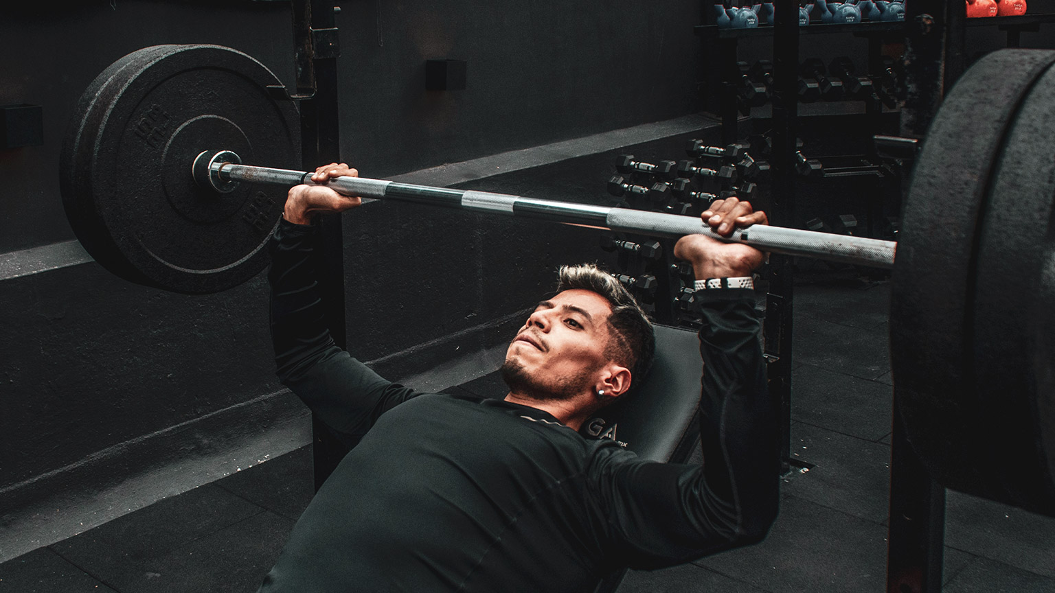 A person doing an incline bench press in a gym