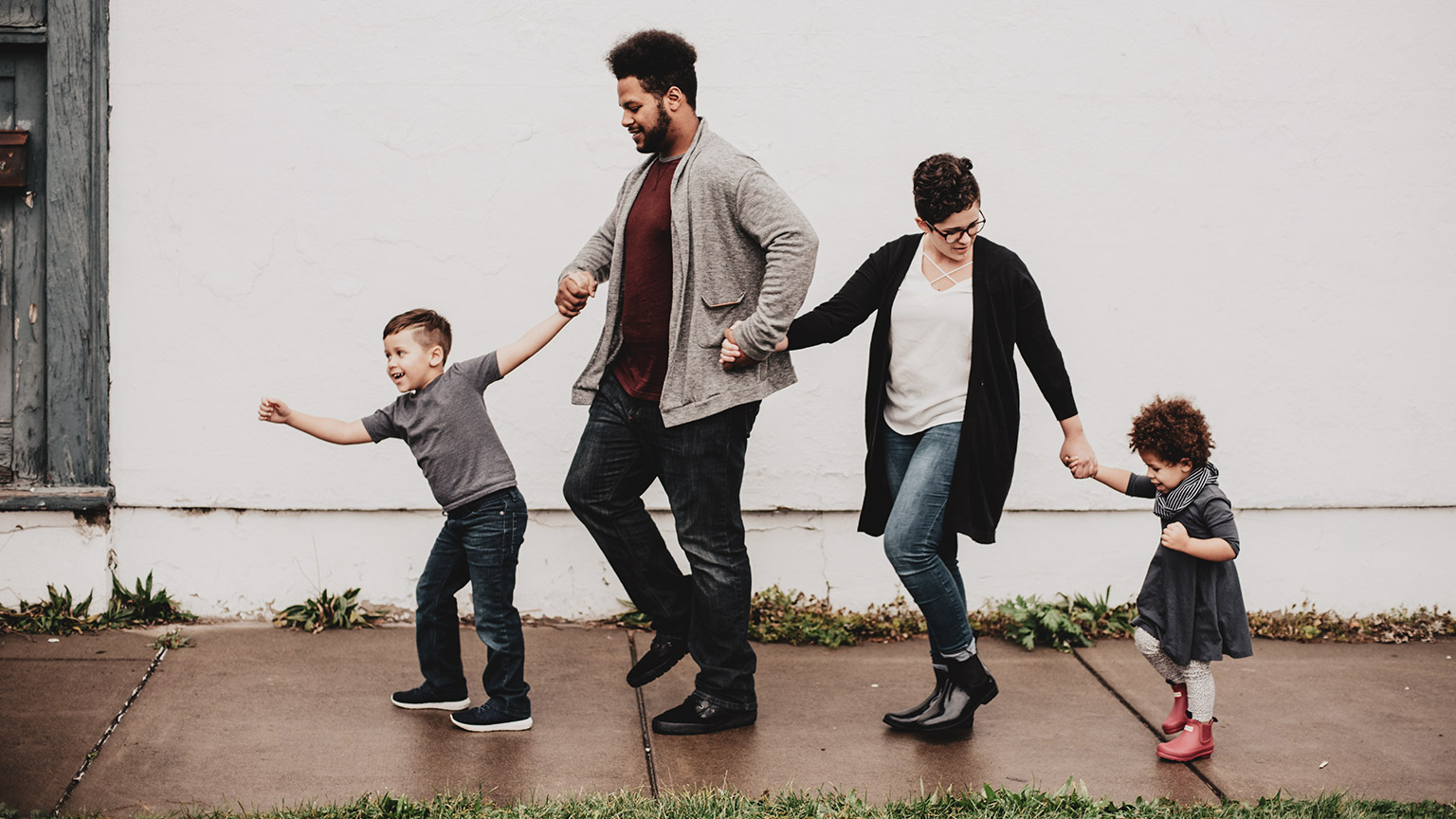 A family with young children walking along a footpath