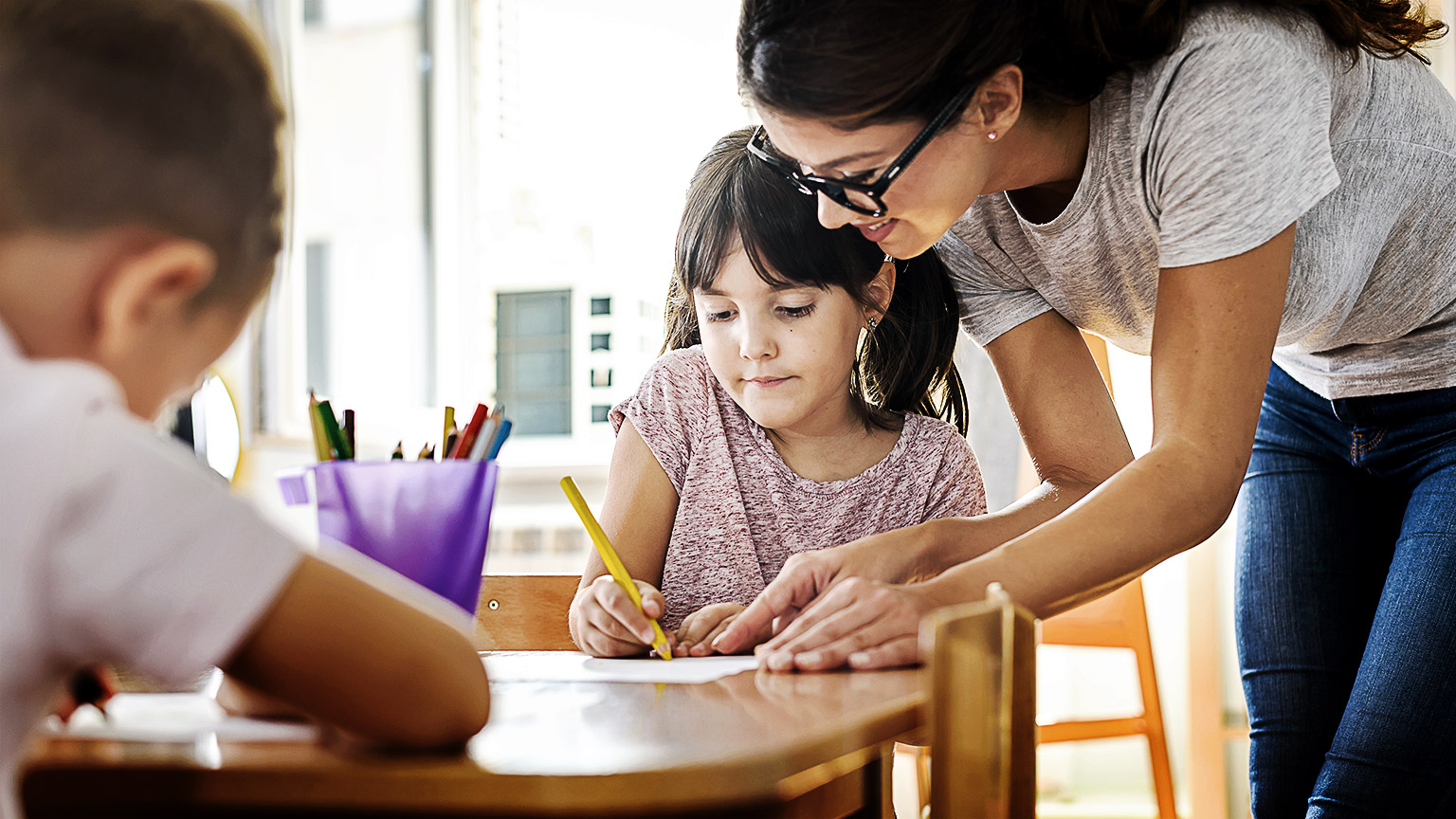 A early childhood teacher handling a student