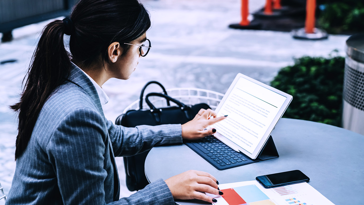 Professional woman reading documents on ipad