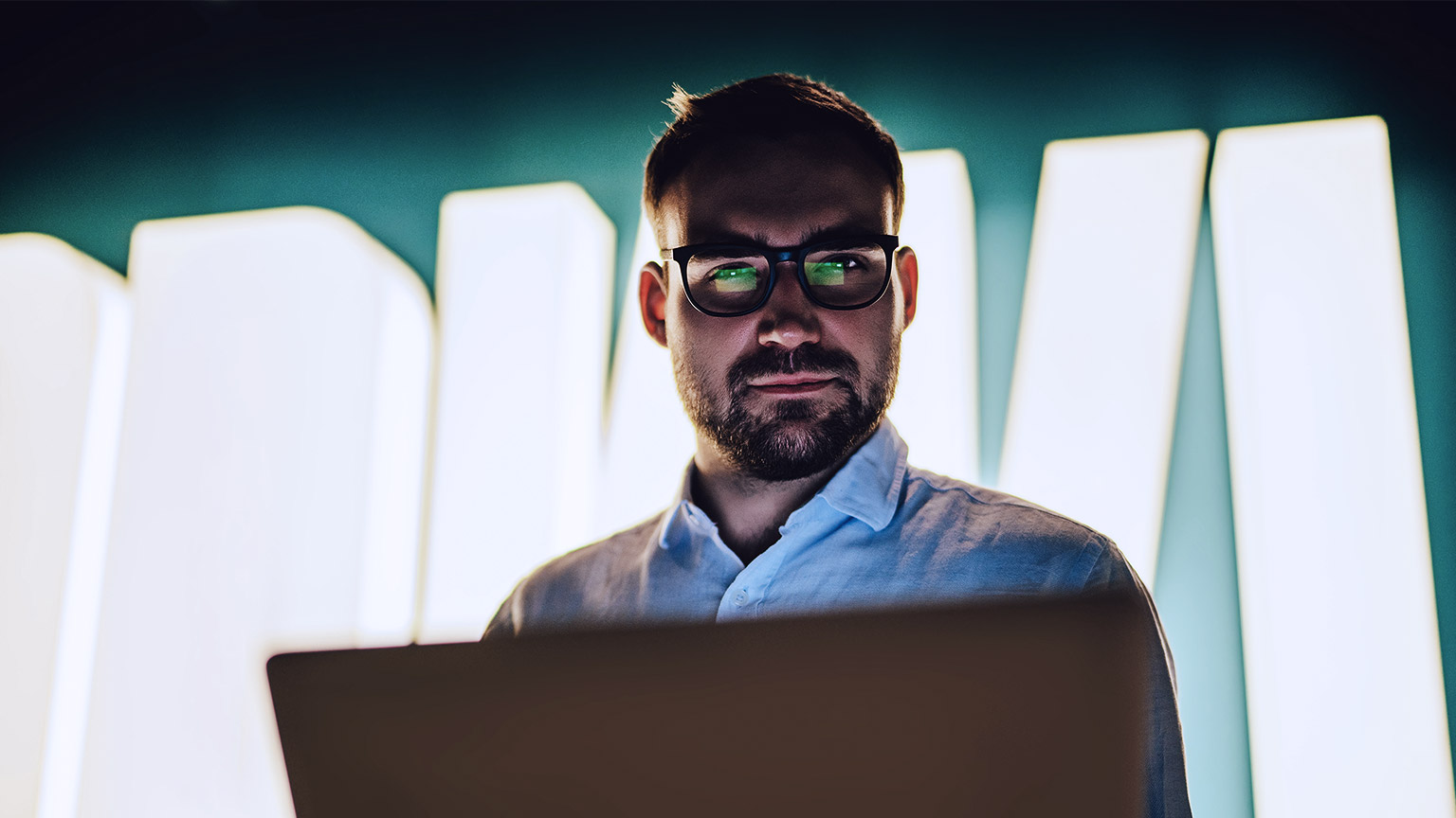 Man with computer looking at camera