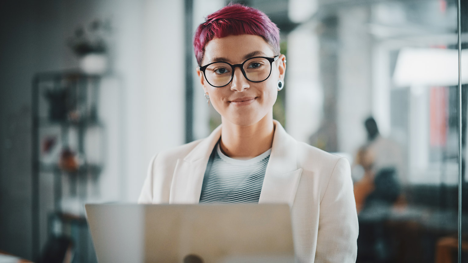 A smiling business professional in a modern office space