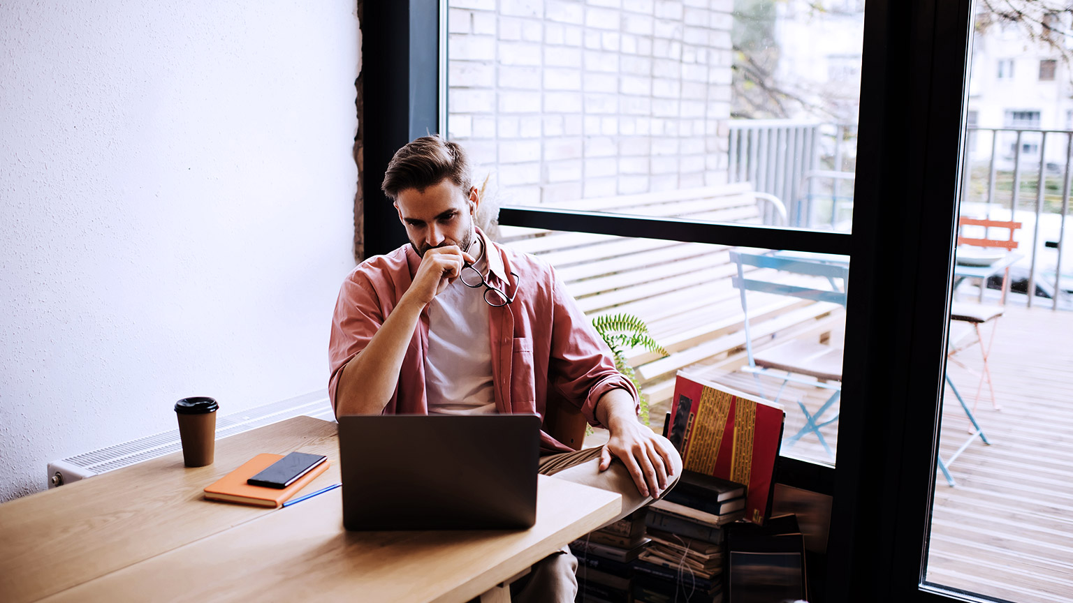 Man thinking, looking at the computer screen