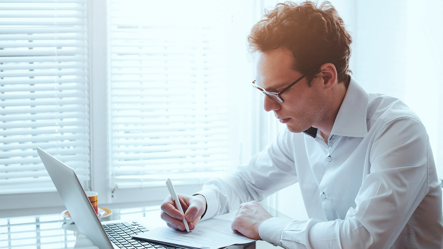 A business manager reading compliance documents