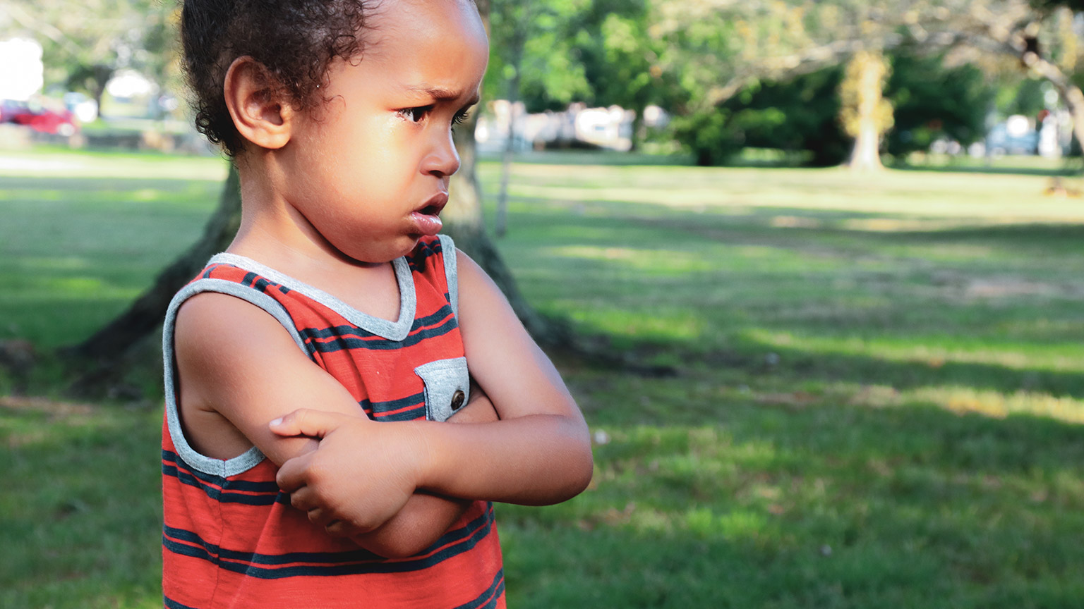 An unhappy child in an outdoor setting