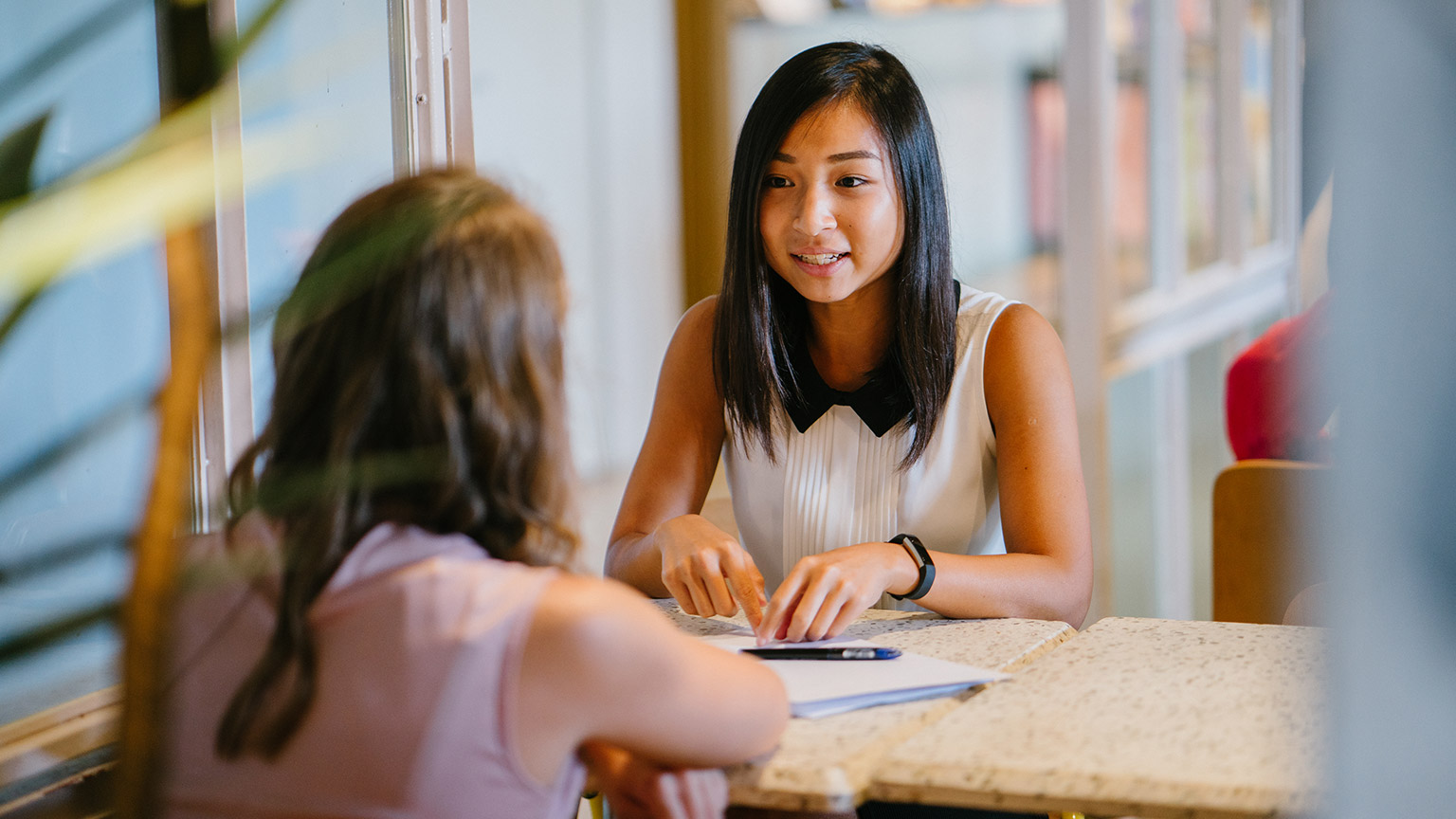 A childcare worker talking to a parent