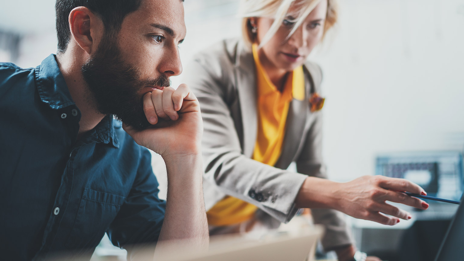 An accountant and client looking at figures on a computer screen