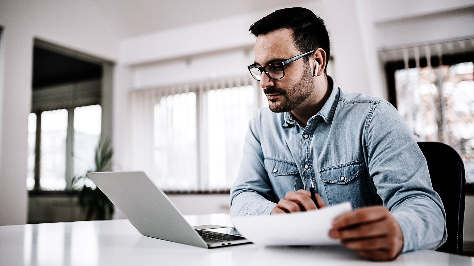 A person with of documents and laptop