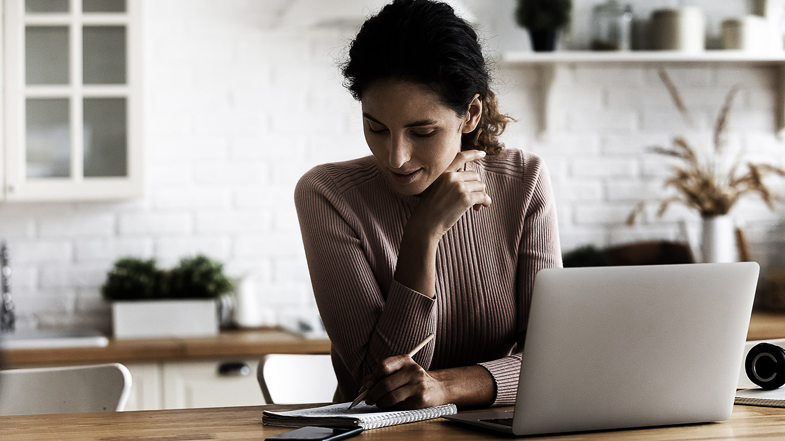 A person researching and taking down notes 