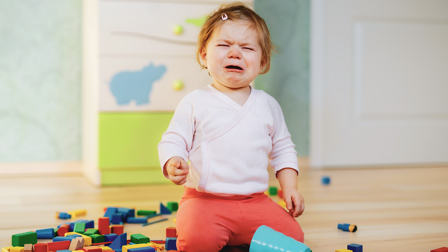 An upset young child in a childcare centre