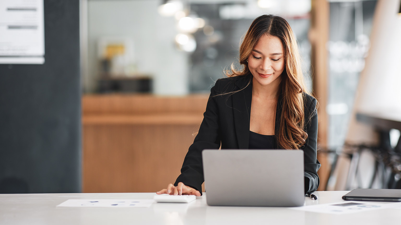 An accountant working on a report on a computer