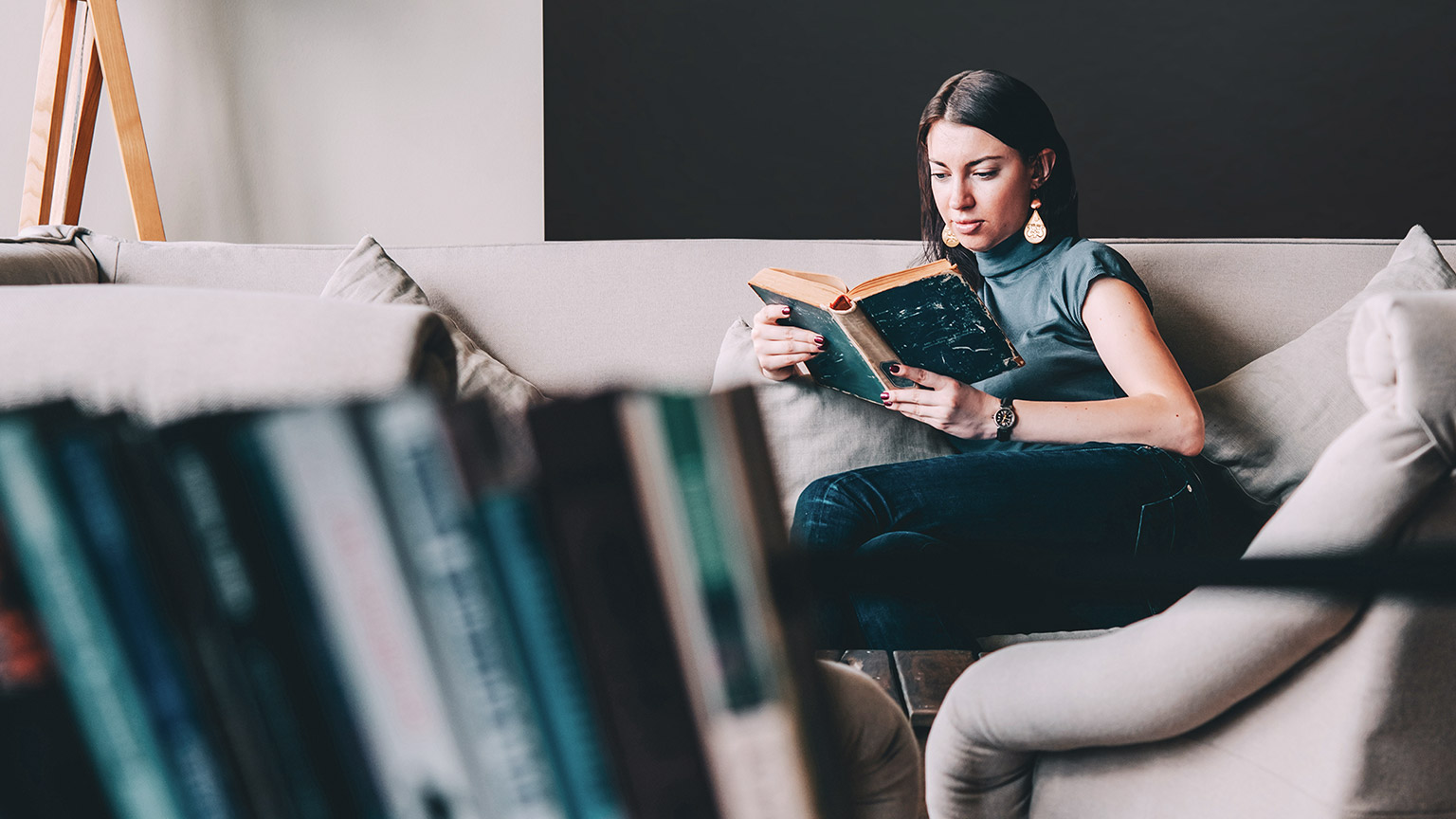 A student reading reference material in a relaxed environment