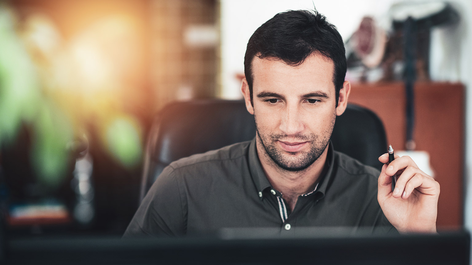 A business professional working on a computer in an office