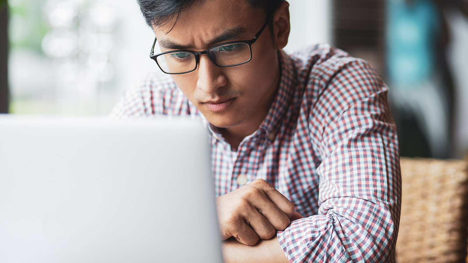 A business person reading legislation information on a laptop