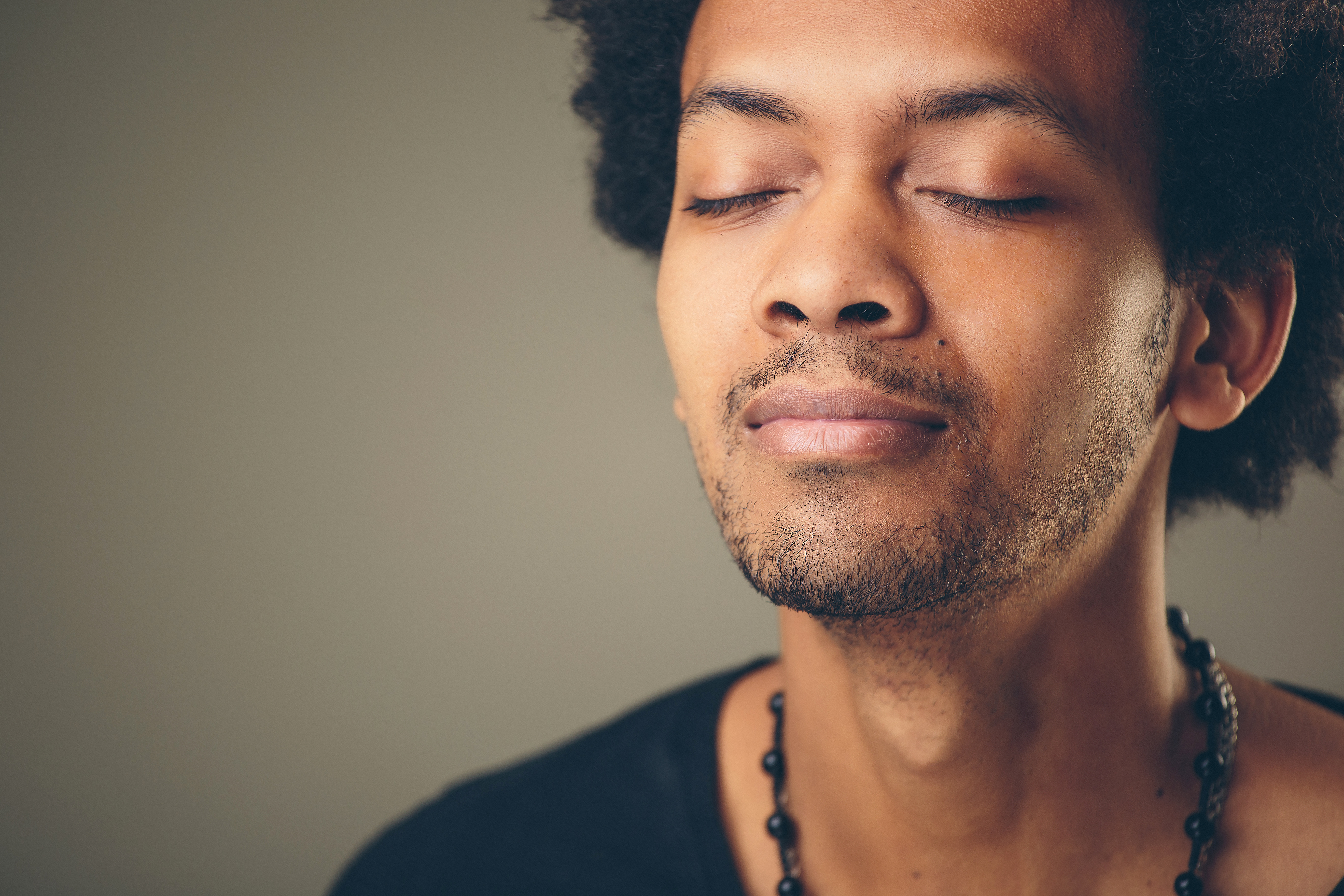 Portrait young man, eyes closed. Stress relief techniques concept take deep breath. Positive human emotions, facial expression.