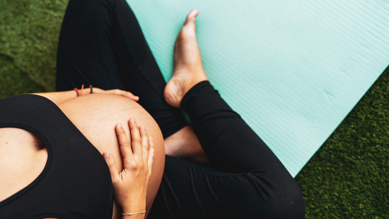 Top down view of a pregnant lady doing exercise