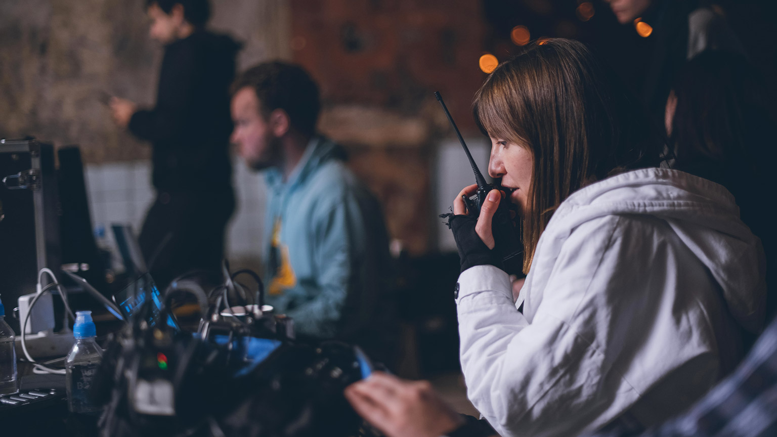 An event director talking on a walkie talkie during a live event