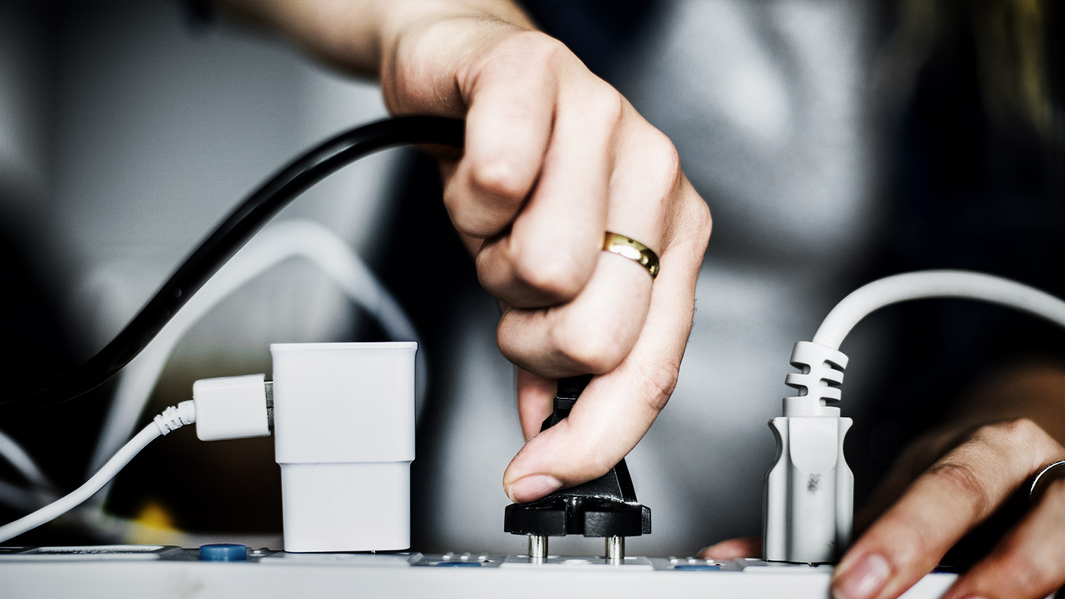 A person plugging in power cables