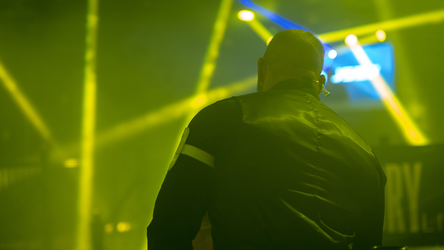 A rear view of a security person at a live event