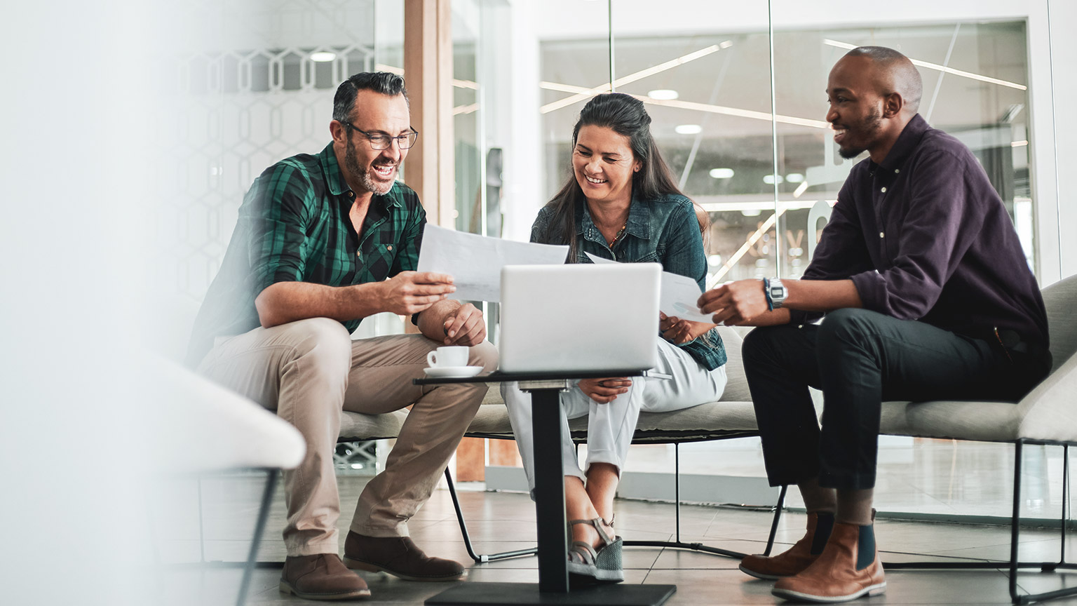 A group of coworkers discussing a project in an office