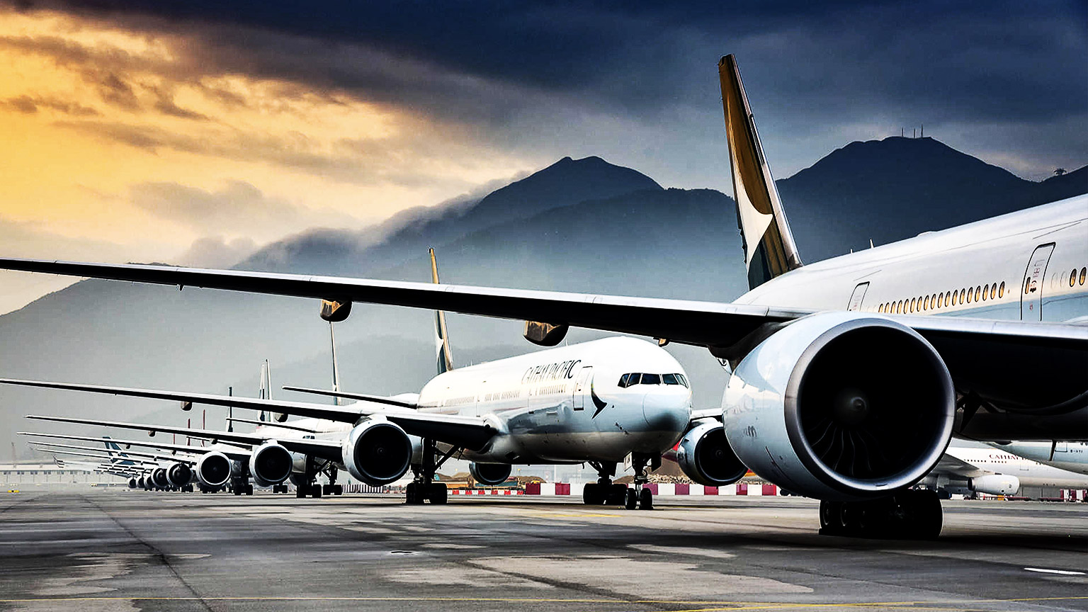 planes on a runway at dusk