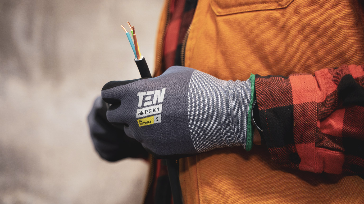 A close view of an electrician holding electrical cables