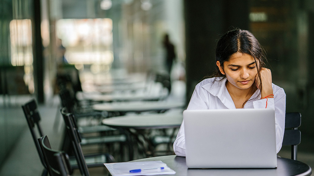 young asian woman typing and working