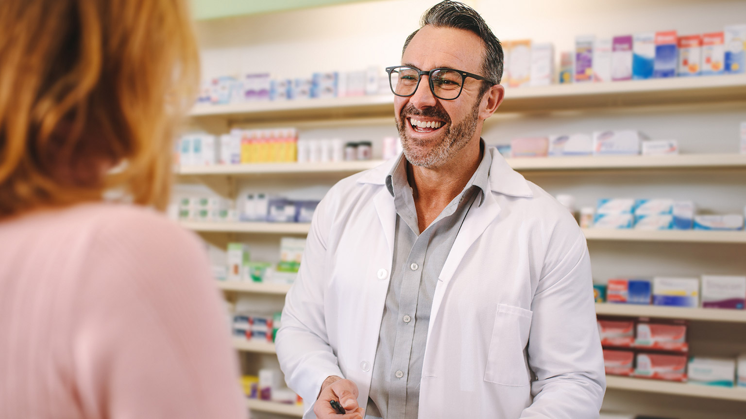 A pharmacist interacting with a client