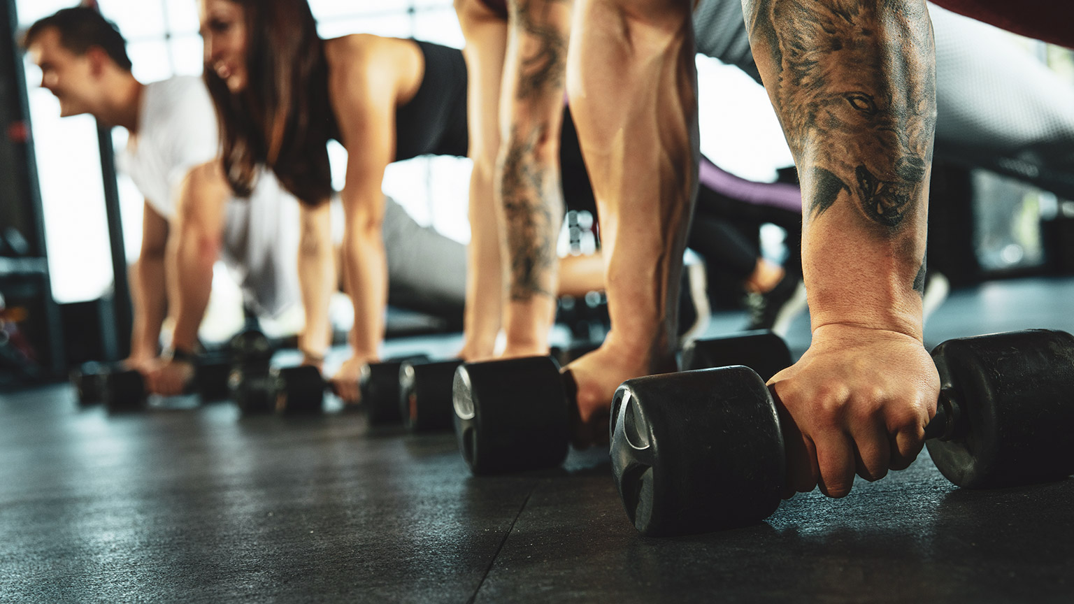 A low shot of a group of people doing an exercise class in a gym