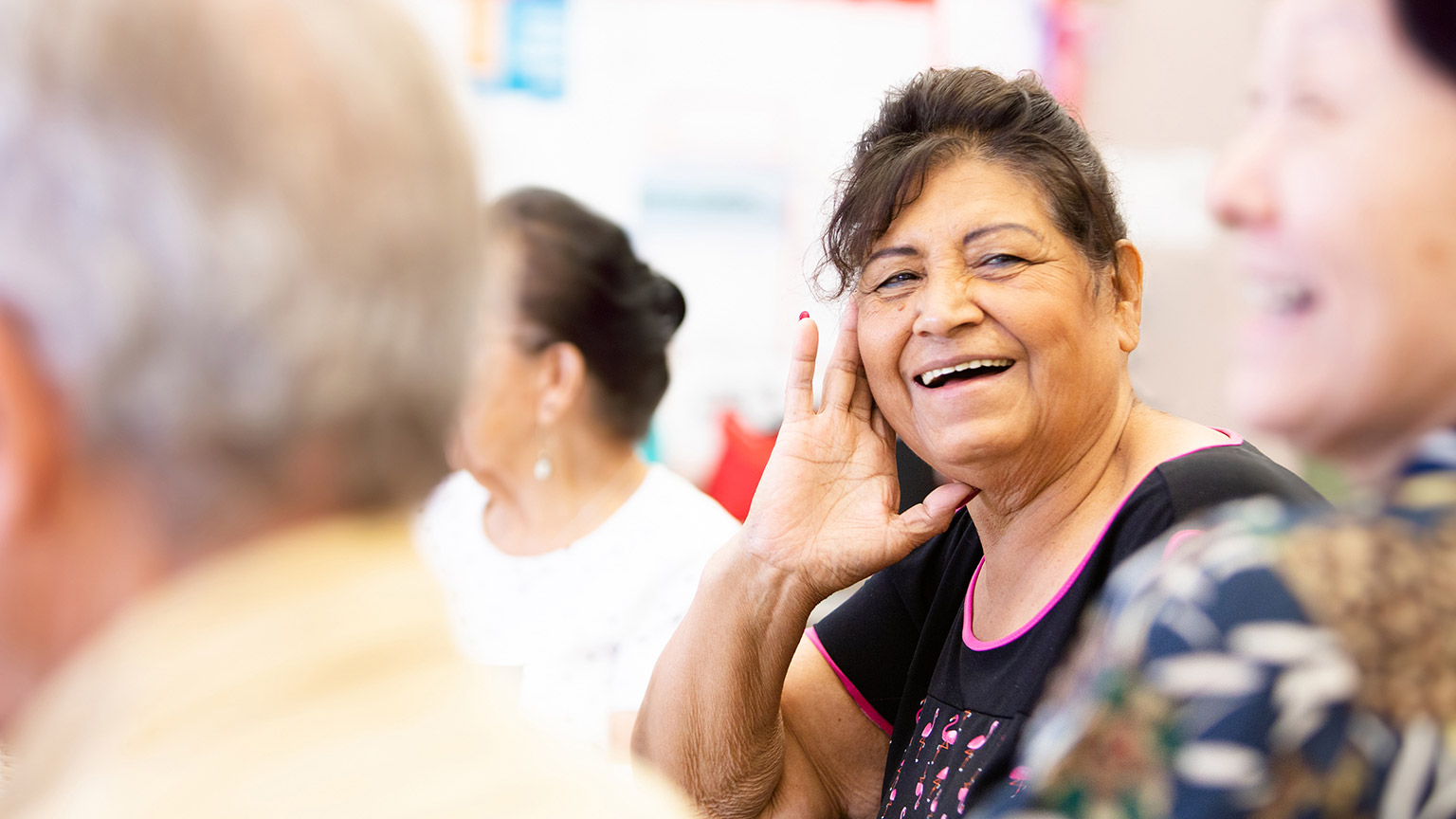 An elderly woman smiling at the camera