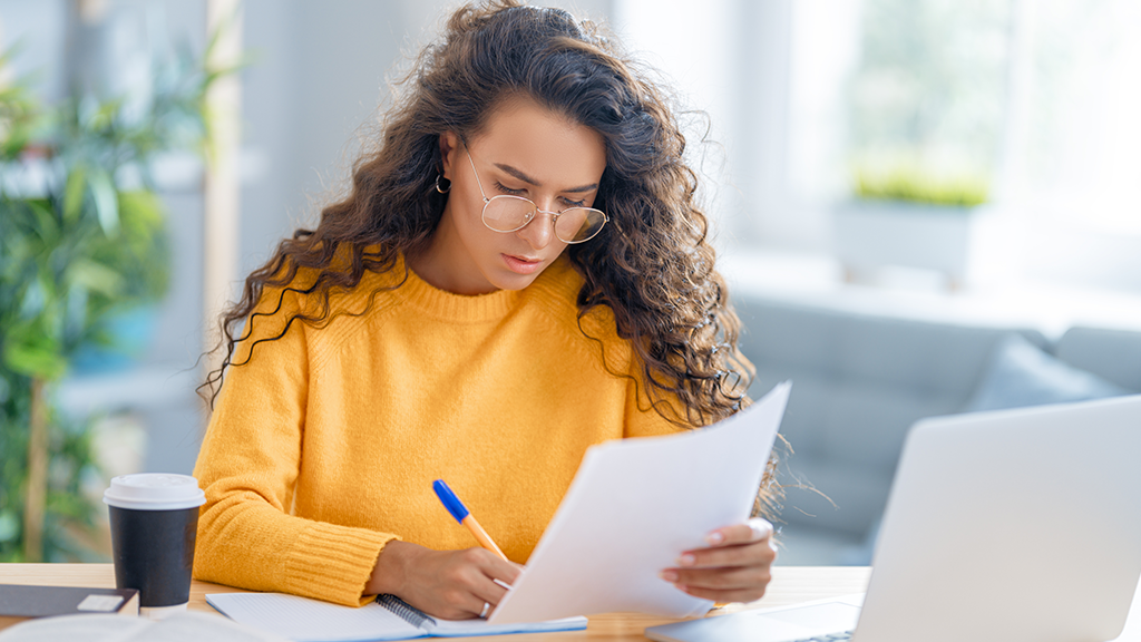 Focused young businesswoman studying online