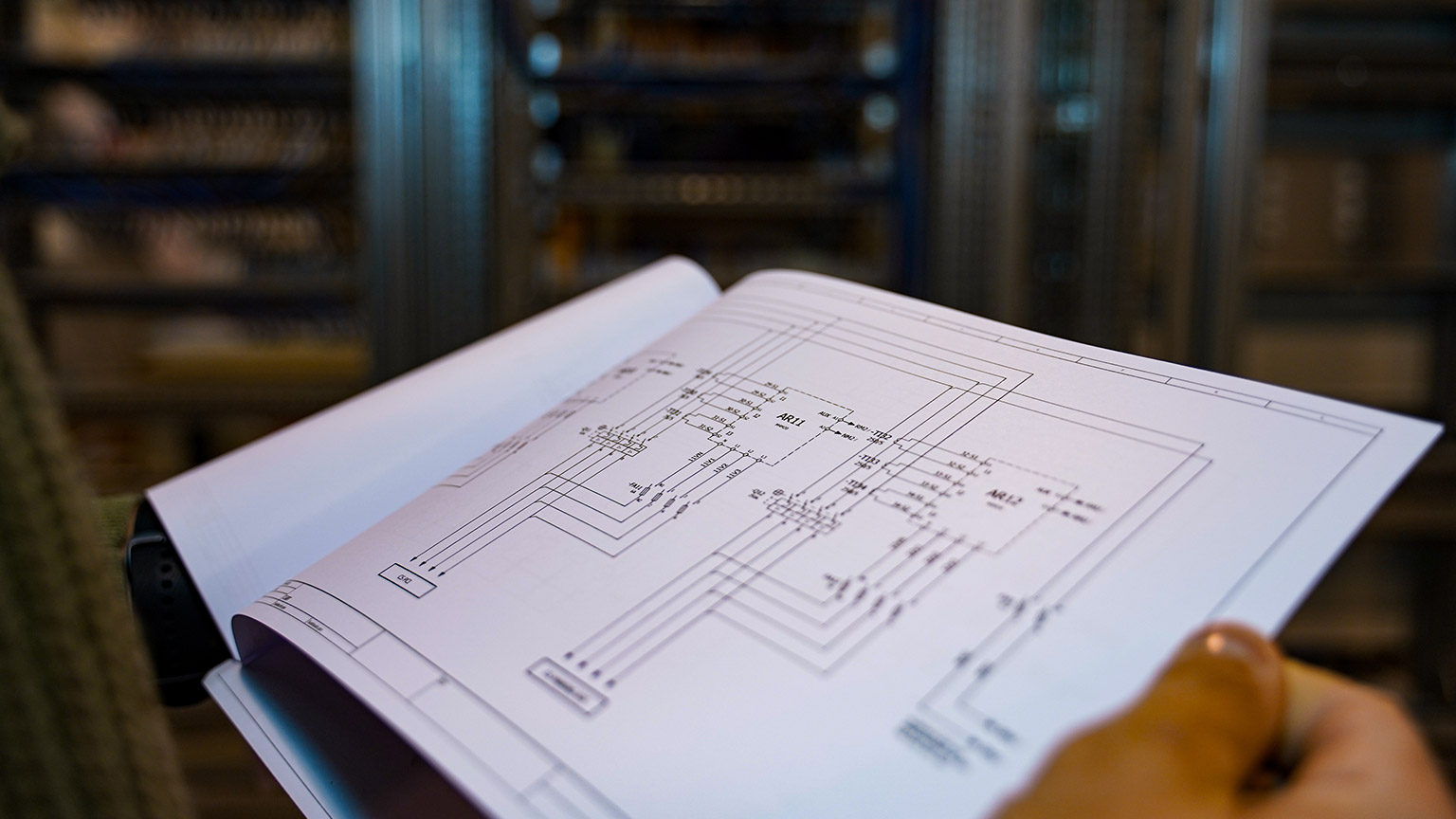 A close view of a person reading an electrical plan