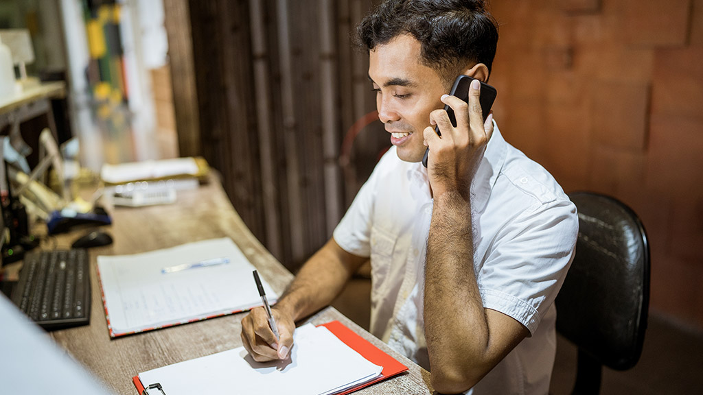 A receptionist taking a phone call