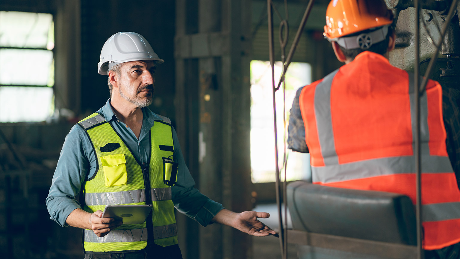 A manager talking to a coworker on a work site