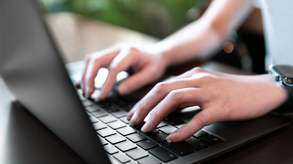 closeup hand typing keyboard