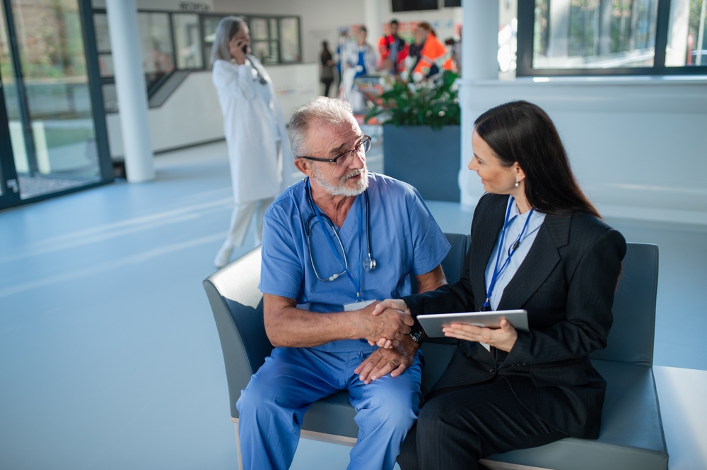 Business woman shaking hands with a doctor in a clinic