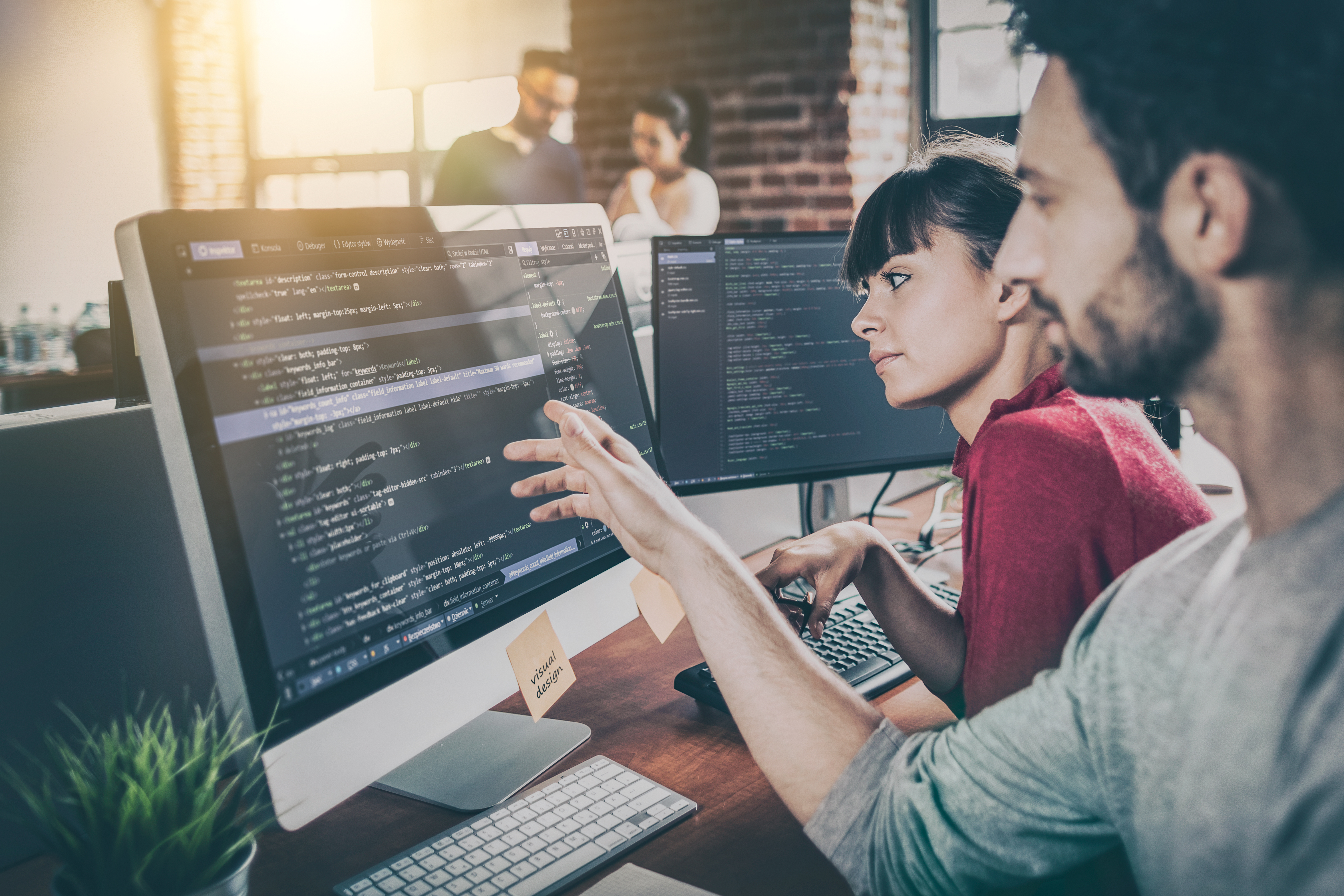 People testing code at a workstation