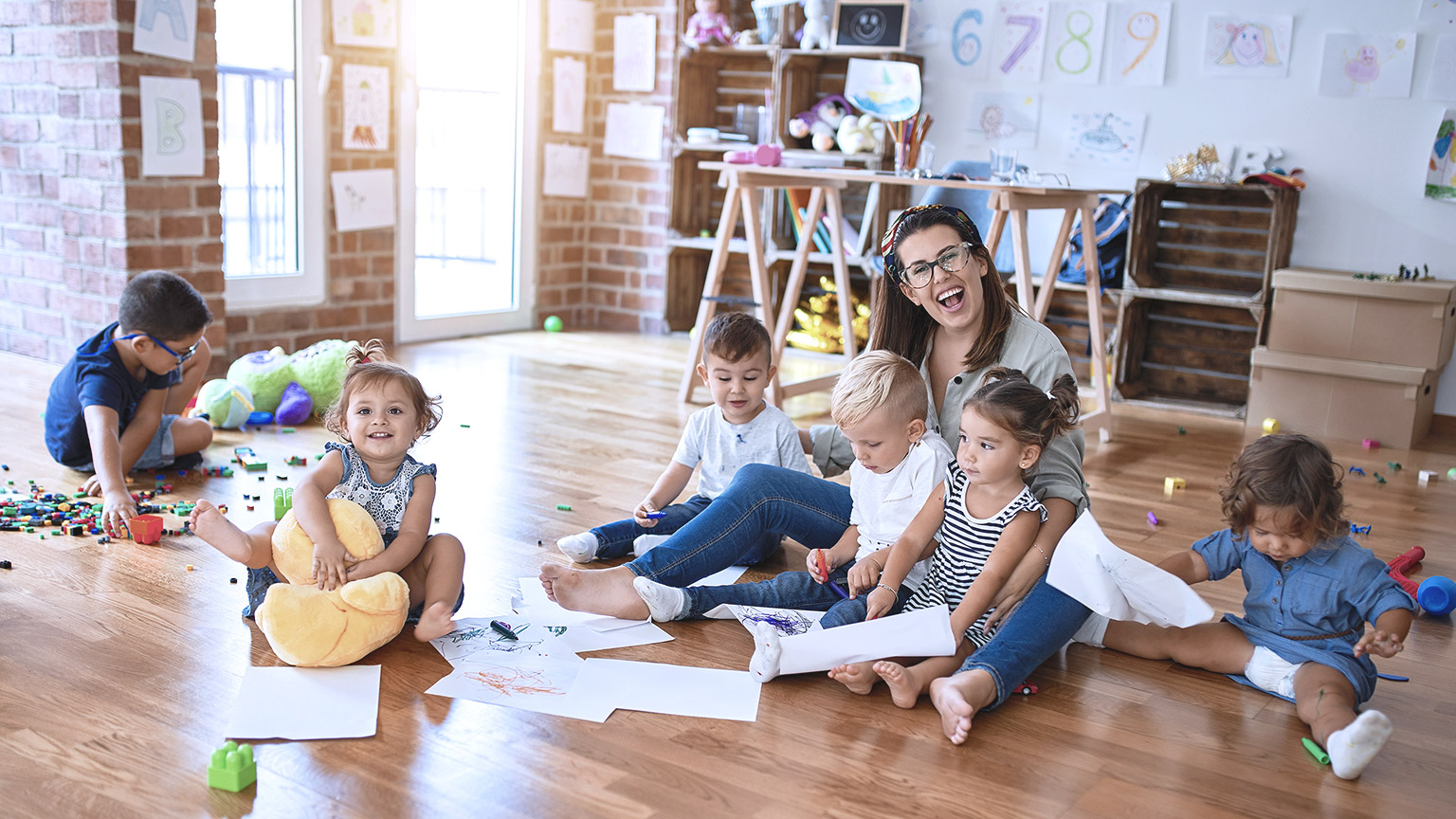 Happy teacher with toddlers