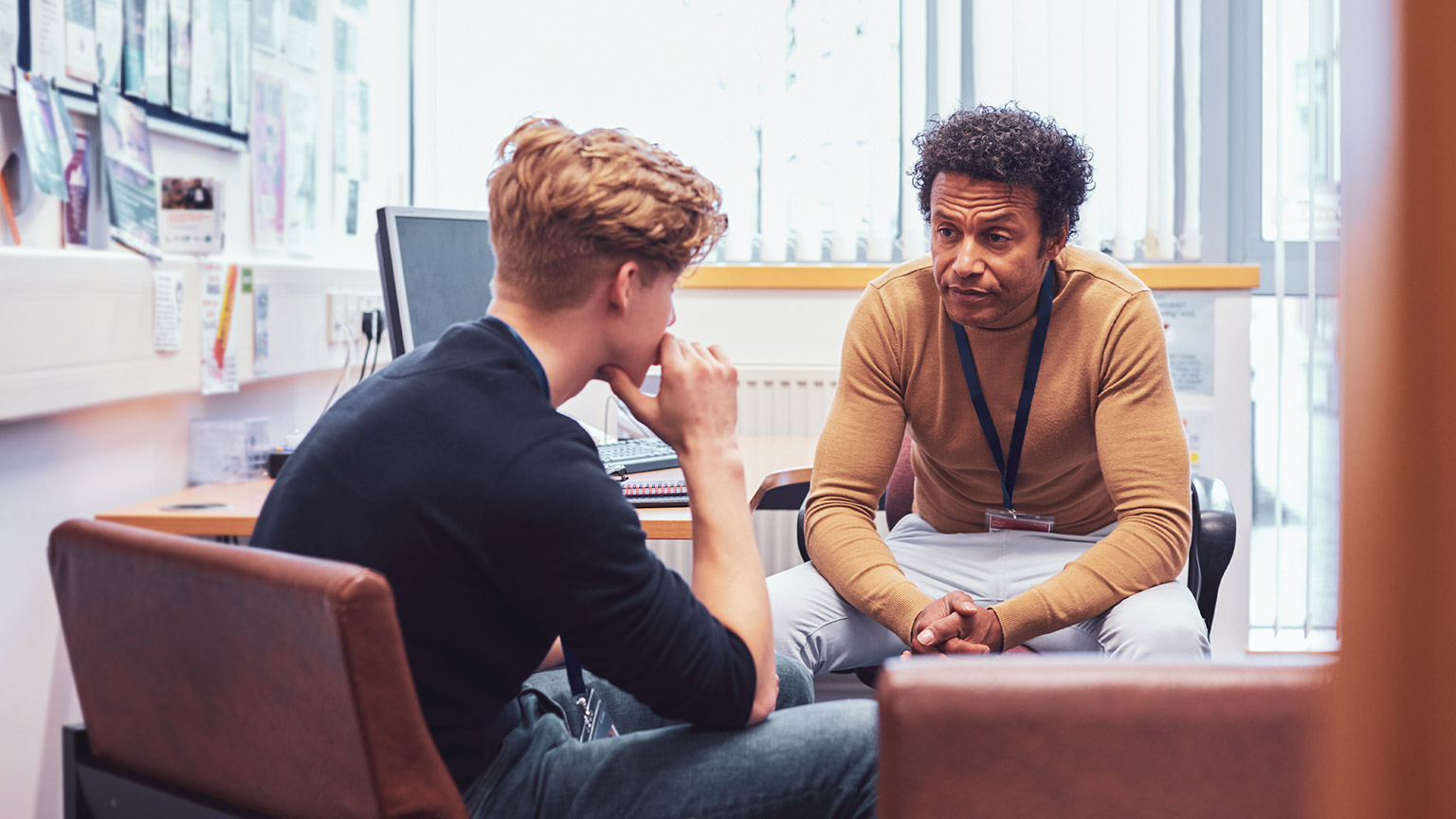 A counsellor with a serious expression talking to a client