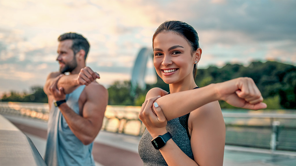 Couple stretching outdoors before morning run