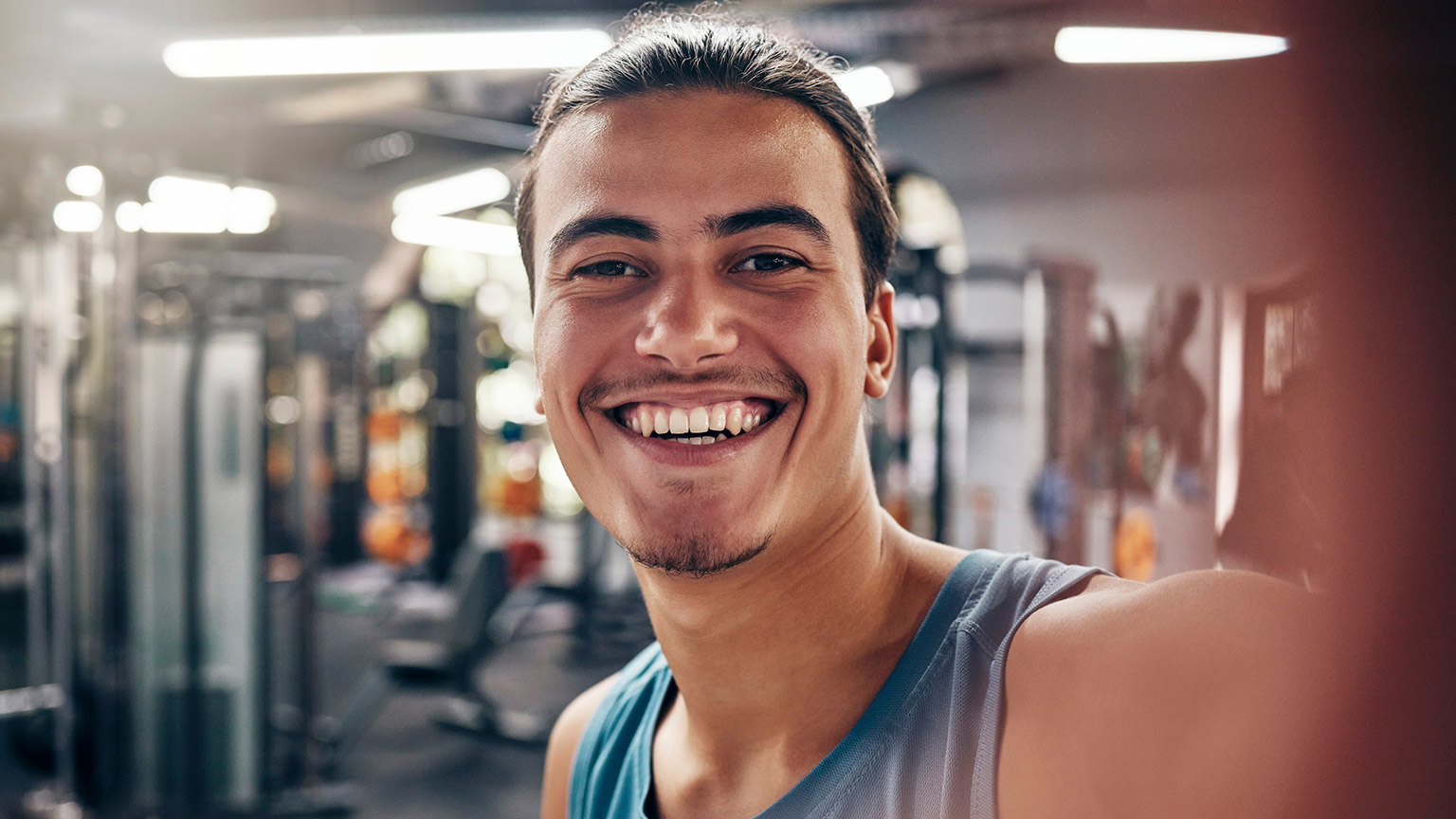 A fitness instructor taking a selfie in a gym