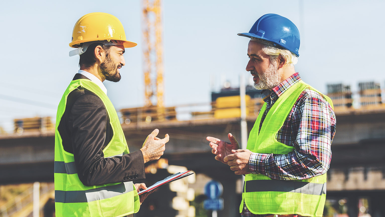 Two men at a job site talking