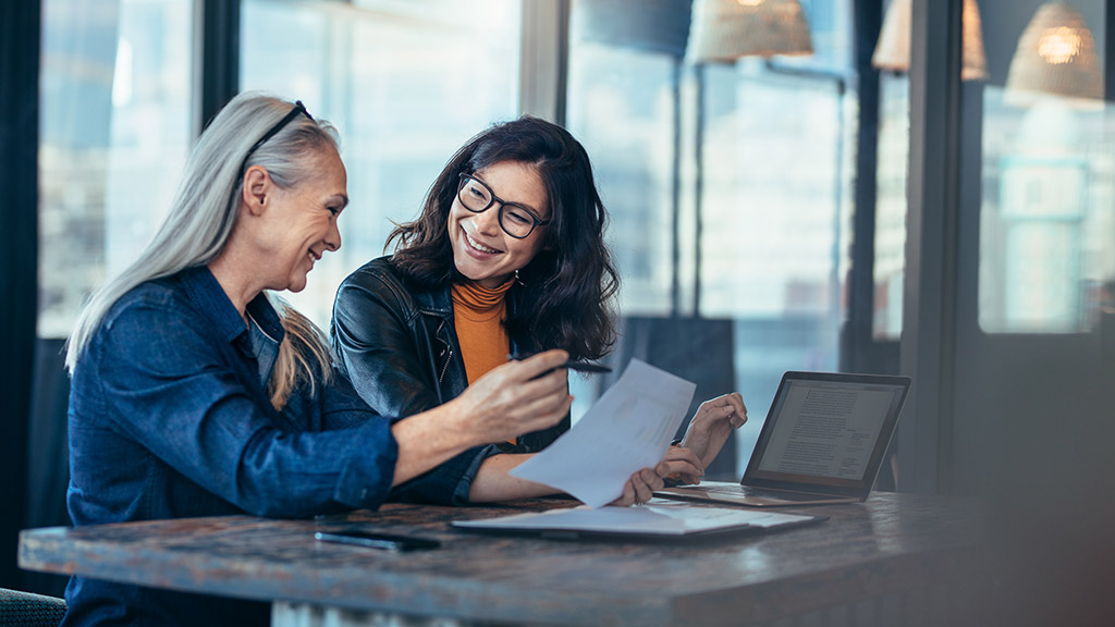 Smiling business woman working together on contract documents