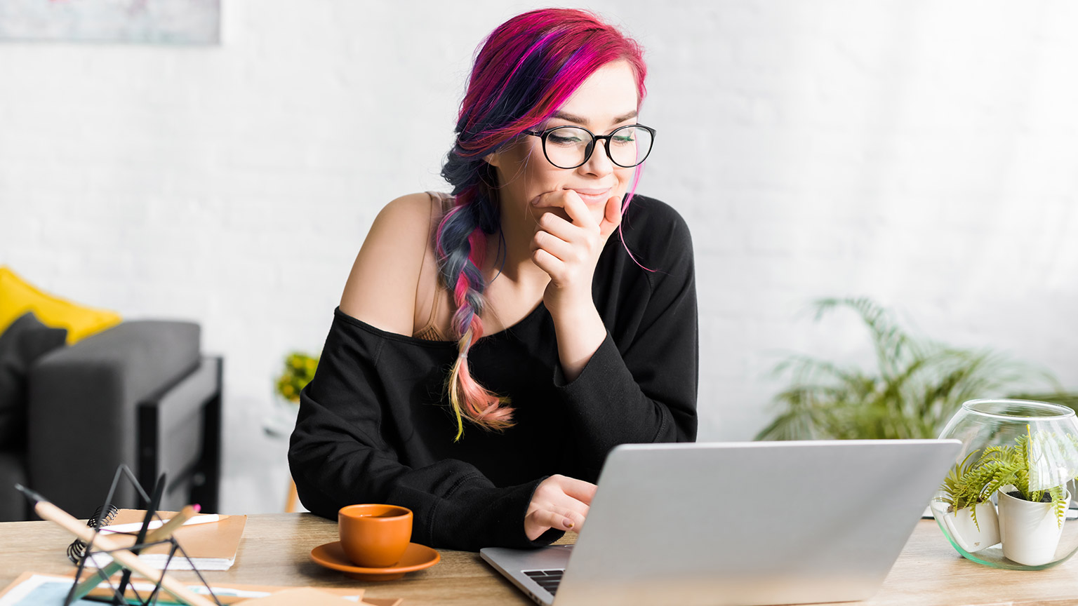 A gamer working on a laptop at a table