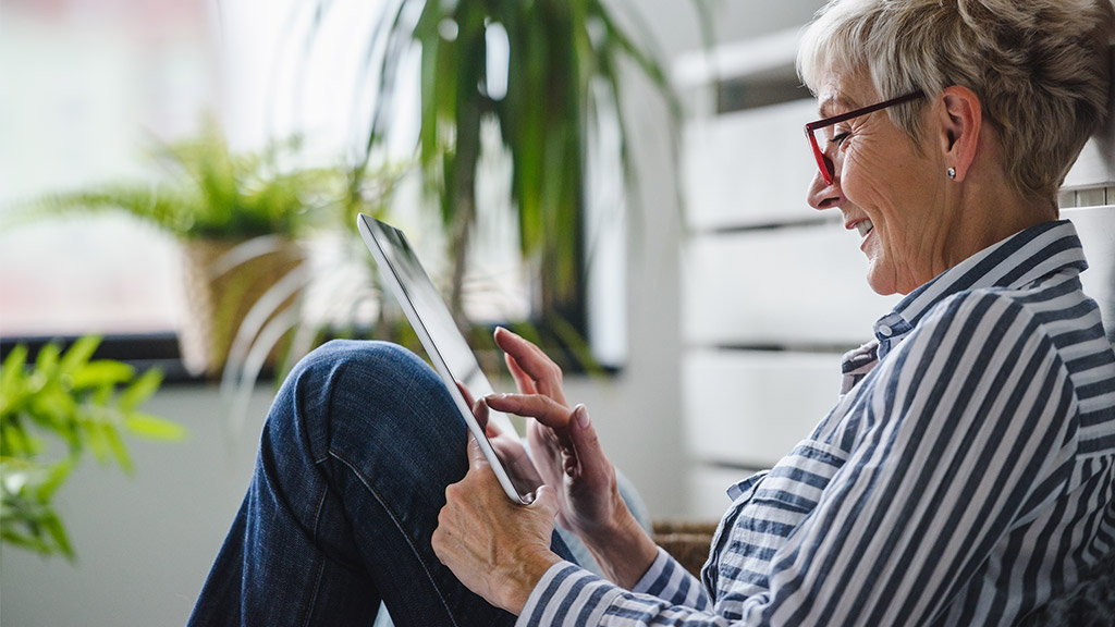 Senior woman using digital tablet at home. The use of technology by the elderly.