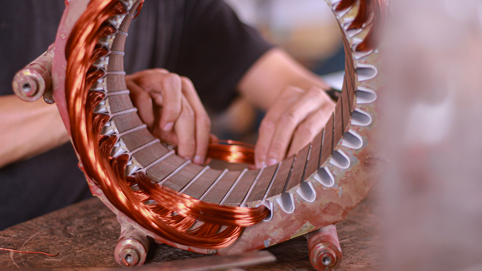 A person changing wiring in a motor