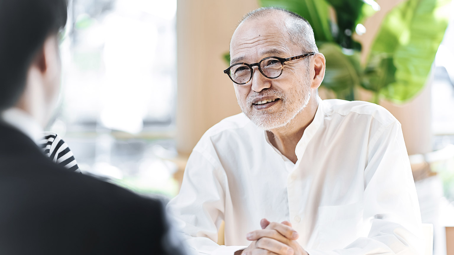 Elder man giving consultation with young professional