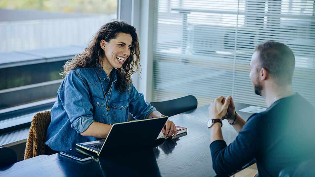 woman taking interview a man inside office