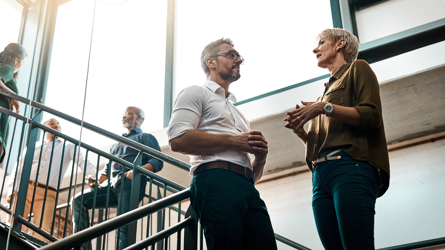 Colleagues having a discussion in a modern office space