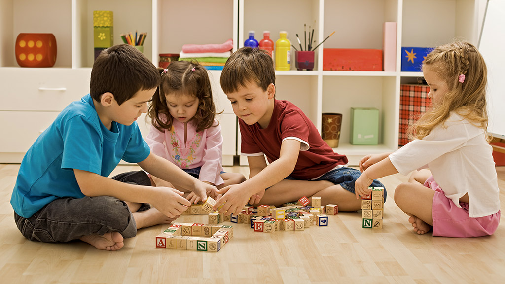 Children playing with blocks on the floor